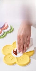Close-up of easy-to-clean silicone cherry blossom trivet being wiped with a tissue