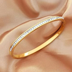 Elegant gold titanium steel bracelet featuring a luxury row of clear cubic zirconia crystals