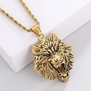 Macro shot of gold roaring wolf head pendant with twisted rope chain on white cube