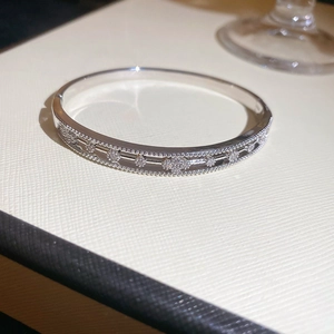 Macro shot of silver plated bangle with pavé zircons and vintage beaded hollow pattern