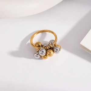 Detail of minimalist two-tone steel bead ring with gold and silver polished accents