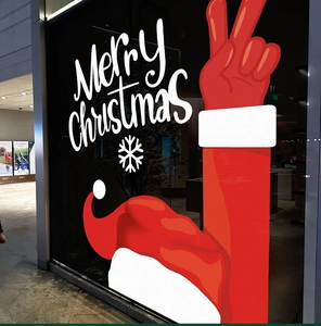 Close-up of a festive red Santa hand window sticker with snowflakes and Merry Christmas text