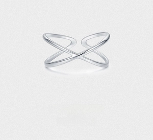 Close-up of minimalist S925 sterling silver ring with intersecting geometric X-shaped lines