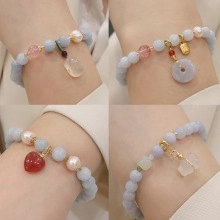 Close-up of beaded bracelets with natural freshwater pearls and various gemstone charms