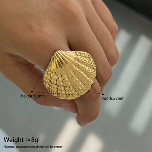 Detail view of gold scallop shell ring with 30mm x 32mm size and weight dimensions