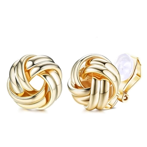 Detail of gold knot ear clips showing clip-on back and silicone pads for non-pierced ears