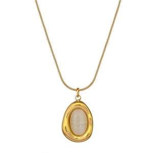 Gold snake chain necklace featuring an irregular waterdrop pendant with white cat-eye stone