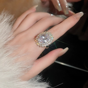 Macro detail of oval cut zircon ring with shimmering halo and diamond-set band