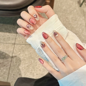 Handmade burgundy and silver cat-eye press-on nails with heart and smiley patterns