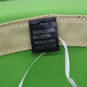 Detail shot of the fabric label showing 65% cotton and 35% polyester on green wool hat