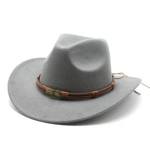 Detail of gray wool cowboy hat with brown braided band and vintage sunburst metal buckle