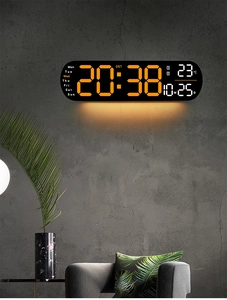 Modern LED digital wall clock with temperature and date display on a concrete wall