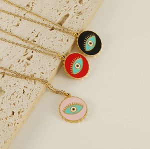 Detailed close-up of 18K gold stainless steel necklaces with colorful enamel evil eye pendants