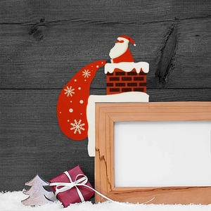 Detail of wooden Santa Claus corner decoration on a frame with festive Christmas scene