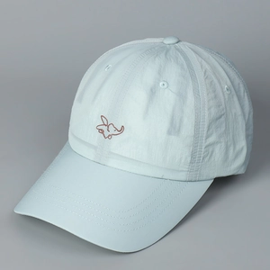Close-up of elephant embroidery on a light blue quick-dry baseball cap with fabric texture