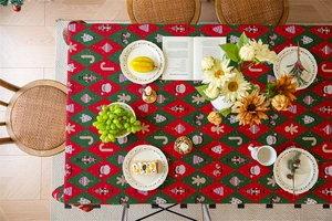 Detail of Christmas tablecloth with green diamond pattern and Santa Nutcracker motifs