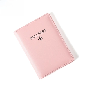Pink faux leather passport holder with RFID protection and minimalist airplane design