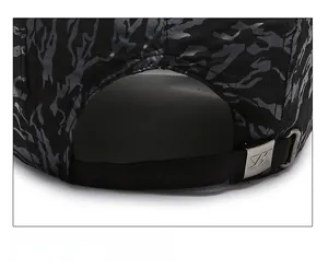 Detail of camouflaged baseball cap with adjustable strap and metal Z-logo buckle