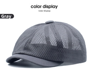Detailed view of grey mesh sun hat showing breathable polyester fabric and short brim