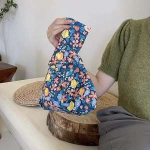 Close-up of floral cotton wrist bag featuring pink flowers and lemon prints
