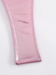 Close-up of pink shiny swimsuit fabric showing high-quality stitching and satin texture