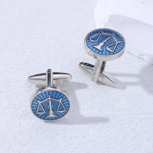 Macro detail of Libra scale cufflinks with blue enamel finish on silver metal