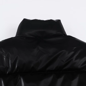 Detail of high-gloss black waterproof fabric and stand collar on winter puffer jacket
