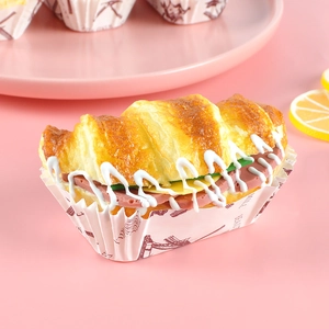 Realistic artificial croissant sandwich model with ham and cheese on pink background