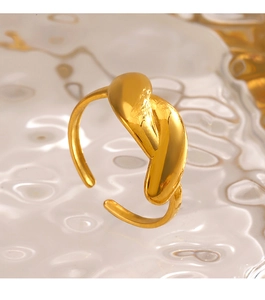 Macro shot of molten-style gold irregular ring with polished finish on glass