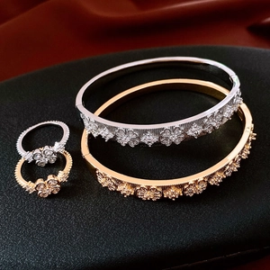 Parure de bijoux luxe plaquée or 18 carats avec motif fleur sur fond de soie rouge chic
