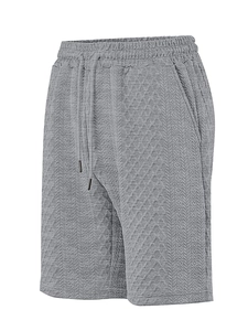 Detailed view of grey waffle knit fabric texture and drawstring waist on men's shorts