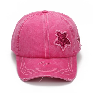 Detailed view of the rose pink star patch with sequins on washed vintage baseball cap