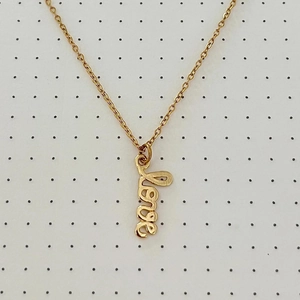 Macro view of gold-plated O-chain necklace with a script Love pendant on display