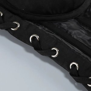 Detailed close-up of black fabric featuring silver metal eyelets and lacing design