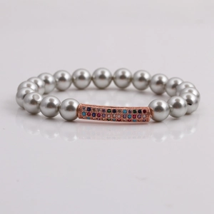 Bracelet en perles de coquillage 8mm avec tube incurvé en or rose et zircons colorés