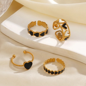 18K gold plated heart enamel rings with hollow flower designs on white marble