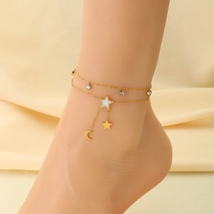 Detail of 18K gold-plated anklet with star, moon pendants and mother-of-pearl inlay