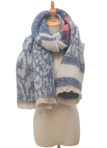 Detailed view of winter scarf with leopard and snowflake patterns on a model mannequin