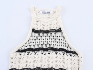 Detail of knit halter dress with contrast black embroidery and bohemian镂空 textures