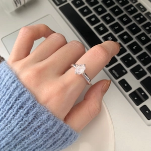 Detailed shot of a 925 sterling silver four-prong rectangular zircon ring on finger