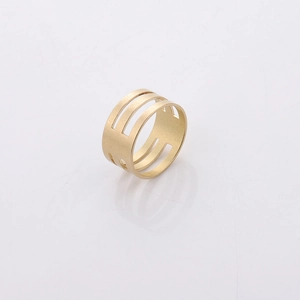 Detail view of a matte gold brass jump ring opener with a triple-layer hollow geometric design