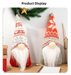 Close-up of two Christmas gnomes with knitted snowflake hats and long white plush beards