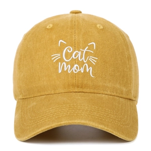 Close-up of Cat Mom white embroidery on yellow washed cotton baseball cap texture