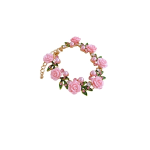 Floral rose bracelet with pink flowers, pearls and crystals on a gold chain