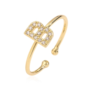 Detailed close-up of adjustable gold ring featuring a cubic zirconia letter B design