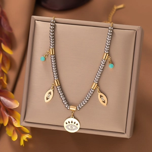 Macro view of ethnic titanium steel necklace with evil eye pendants on jewelry box