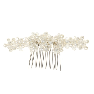 Detailed view of handmade bridal hair comb with pearls and crystals on silver metal teeth