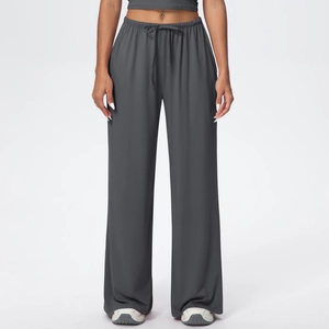 Detail of dark grey wide leg trousers featuring an elastic waist and matching drawstring