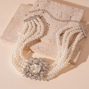 Detailed view of luxury 5-layer pearl necklace with a vintage crystal square pendant