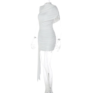 Detail of elegant white ruched dress with asymmetric shoulder cape and flowing ribbon